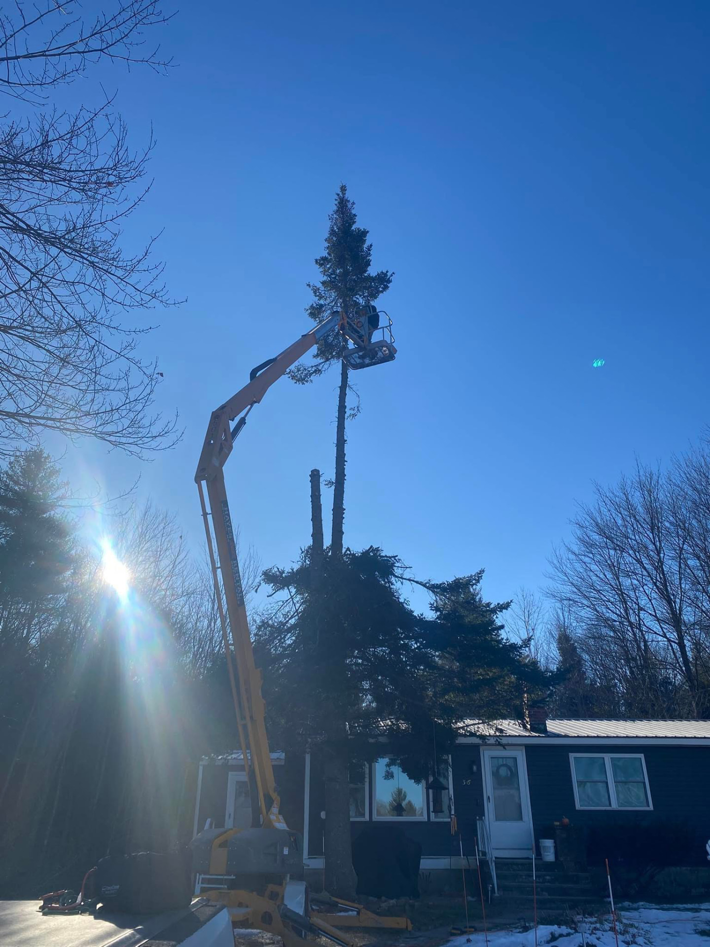 Lift used to take down trees close to a home in Western Maine
